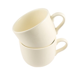 Ceramic cream colored cup pile isolated