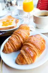 Breakfast with coffee and croissants