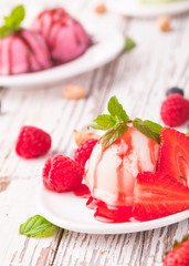 Strawberry ice cream in cup on wood