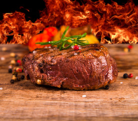 Grilled steaks on wood