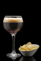 Brown beer isolated on black