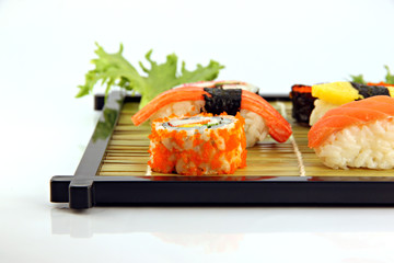 Sushi arrange them on a bamboo dish.