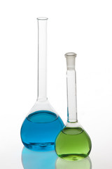 Set of laboratory flasks filled with multicolored liquids, isola