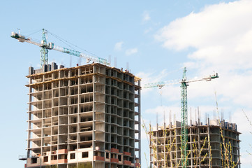 Fototapeta na wymiar Construction of a high-rise building with a crane.