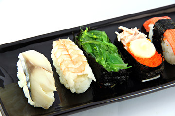 Sushi made ​​from seafood on Black dish.
