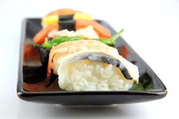 Sushi made ​​from seafood on Black dish.