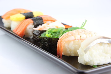 Sushi made ​​from seafood on Black dish.