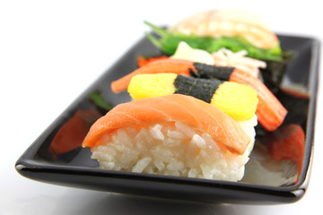 Sushi made ​​from seafood on Black dish.