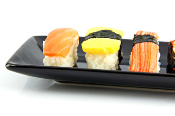 Sushi made ​​from seafood on Black dish.
