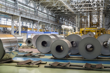 Rolls of aluminum lie in production shop of plant