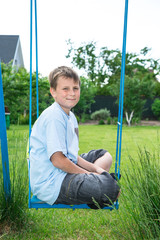 teenager sitting on a swing