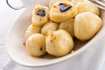 Potato dumplings with plums full