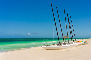 Sailing boats and pedalos on Varadero beach in Cuba