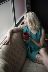 Beautiful Young Woman  Holding Red Coffee Cup © thepoeticimage