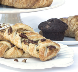 Continental breakfast table setting with pastries and cakes