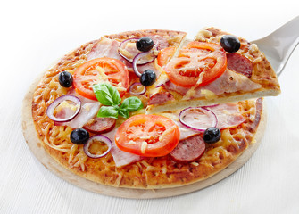 Pizza with salami, bacon, tomato and black olives