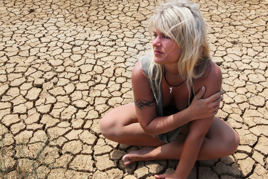 Female sitting on the desert floor