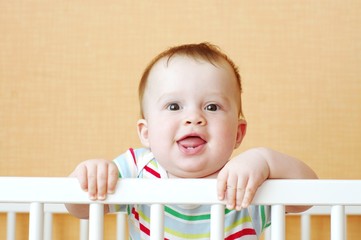 funny baby in white bed