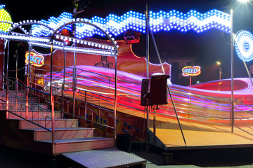 Colorful carousel full of lights at amusement park