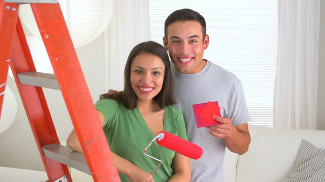 Happy Mexican couple doing home improvements