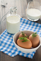 Eggs and milk on wooden background