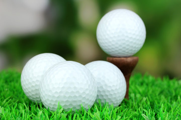 Golf balls on grass outdoor close up
