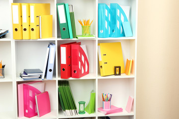 White office shelves with different stationery, close up