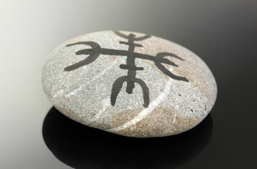 Fortune telling  with symbols on stone on black background