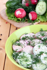Vitamin vegetable salad in bowl on wooden table close-up