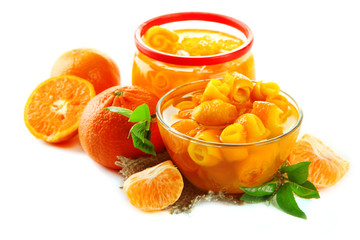 Orange jam with zest and tangerines, isolated on white