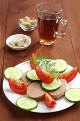 Sandwich with liver sausage and cup tea