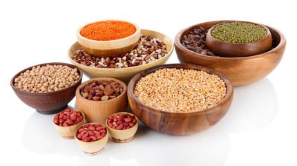 Different kinds of beans in bowls isolated on white