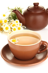 Cup of herbal tea with camomiles close up