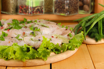 Chicken meat on wooden board,herbs and spices close-up