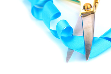 Satin ribbon curled around scissors isolated on white
