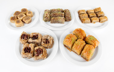 Sweet baklava on plates isolated on white