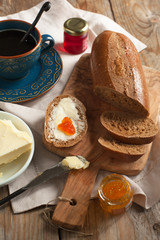 Breakfast with coffee, bread, butter and jam