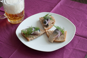 Pickled herring appetizer and beer