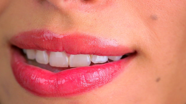 Extreme close up of woman biting lower lip