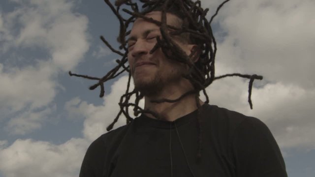 Attractive Young Man With Dreadlocks Head Banging