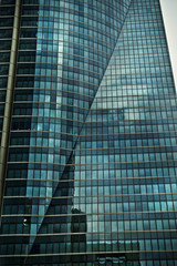 Fototapeta na wymiar Office glasses, clouds reflect on crystal skyscraper