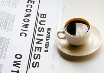 Coffee cup and newspaper