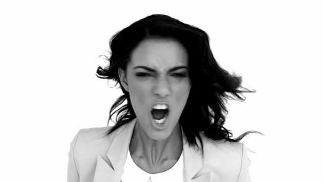 Businesswoman angrily shaking her head in black and white