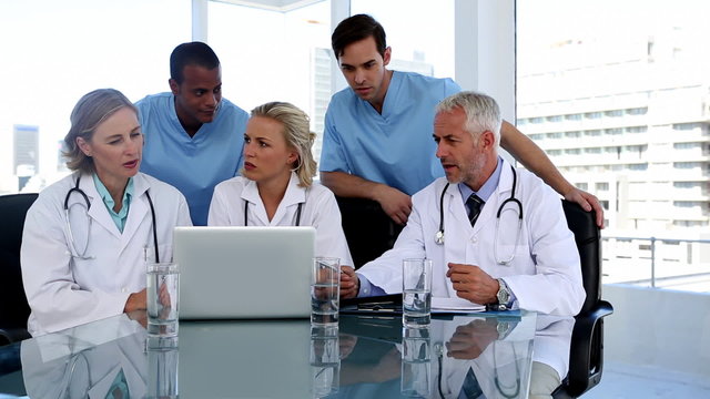 Group of doctors using a laptop together