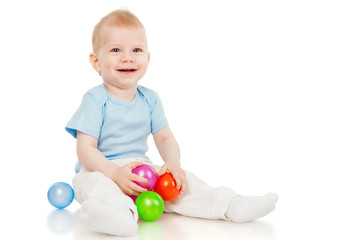 Fototapeta na wymiar The little boy with toy balls