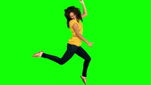 Woman jumping on green screen