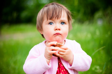 little girl eats bagel