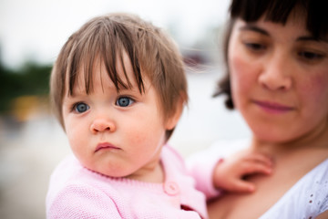 young mother playing with her ​​little daughter on nature