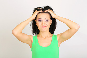 Fototapeta premium Young woman have headache on grey background