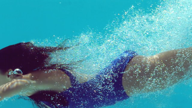 Brunette woman swimming underwater